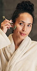 Woman, skincare and jade roller in bathroom with anti aging, lymphatic drainage and beauty cosmetics. Smile, person and product in home with facial massage, reflection and blood circulation benefits
