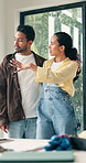 Couple, hug and talking at house for renovation, planning and interior design for lounge makeover. People, discussion and embrace in living room for decor project, diy remodeling and home improvement