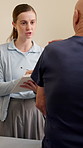 Clipboard, physiotherapist and senior man with arm injury, pain or accident with consultation. Checkup, checklist and elderly patient with recovery or healing for muscle sprain at physical therapy.