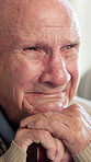 Thinking, crying and senior man in home with grief, loss or nostalgia for past in living room. Sad, walking stick and elderly person in retirement with tears, emotions or feelings for reflection.