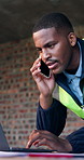 Black man, laptop and phone call on construction site for blueprint, inspection or update planning. Infrastructure, quality control and engineer with tech, chat or project management for remodeling
