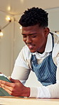 Black man, barista and tablet with scroll for menu, social media and break in food truck cafe. Person, tech and waiter for customer service, partnership or mobile coffee shop review for communication