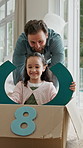 Dad, daughter and playing with box in new home for relocation, bonding or fun childhood together. Father, pushing and child in cardboard package for playful car ride, movement or imagination in house