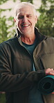 Face, man and happy with yoga mat outdoor, exercise and wellness with equipment for hobby. Male person, smile and senior yogi in portrait with fitness for balance, health benefits and retirement