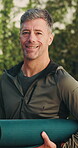 Face, man and smile with yoga mat outdoor, exercise and wellness with equipment for hobby. Male person, happy and mature yogi in portrait with fitness for balance, health benefits and confident