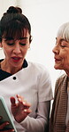 Senior woman, smile and caregiver with tablet in house, consultation or explaining medical diagnosis. Retirement, home and nurse with tech, talk and healthcare information on web for elderly person