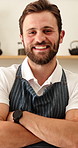 Face, man and server with arms crossed in cafe, entrepreneur and about us for hospitality. Portrait, male person and business owner at coffee shop with smile, positive attitude and catering industry