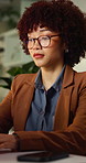 Serious, online and businesswoman with computer in office, working late and financial updates on web. Night, treasury manager and person with glasses, research and risk assessment with technology