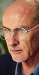 Thinking, glasses and business man in office for planning, reading and ideas for story headline. Publishing, mature and person with reflection, inspiration and solution for project at creative agency