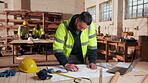 Blueprint, engineer and writing with man in workshop for site plan scale, review or property development. Layout, renovation and architect design with person for expansion, project or building
