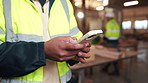 Carpenter, hands and typing in workshop with phone, production update and email for woodwork order. Person, browse and worker in factory with tech, carpentry website and research for manufacturing.