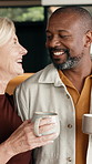 Morning, coffee and mature couple in house with conversation, connection or smile for bonding together. Happy, interracial marriage and people in home with tea, discussion and romantic relationship.
