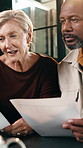 Couple, finance or discussion with documents in home for budget planning, expenses or bills together. Interracial relationship, man and woman with paperwork for financial report or analysis in house