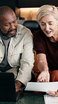 Laptop, interracial couple and budget paperwork in home, mortgage planning or laughing. Savings, mature man or woman at house with tech, asset growth or writing on investment document with funny joke