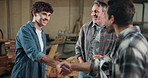 Carpentry, handshake and teamwork with men in factory together for discussion or meeting. Agreement, deal and partnership with happy people shaking hands in woodworking plant for manufacturing
