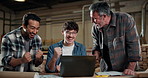 Carpentry, fist pump and laptop with men in factory together for achievement or success. Computer, handshake and high five with happy people in woodworking plant for celebration of production goals