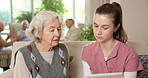 Senior, woman and nurse with tablet in retirement home for medical schedule or prescription. Female person, healthcare worker or caregiver talking with technology for elderly care or health checkup