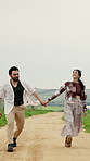 Holiday, running or couple in countryside with holding hands, bonding together or happy moment on trip. Laugh, space or people with fun, romantic relationship or playful connection on outdoor getaway