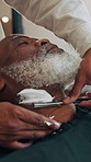 Barber, man and shaving beard in hairdresser with cream, grooming service and haircut with cosmetics. People, senior customer and facial hair removal in salon with foam, razor tools and maintenance.