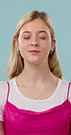 Breathing, meditation and woman in studio with calm, zen or peaceful personality with healing. Smile, gratitude and person with chakra balancing for wellness, health or mindfulness on blue background