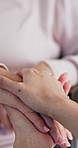 People, comfort and holding hands with senior for love, trust or support in retirement home. Closeup, elderly care or touch with empathy, understanding or grief for loss, health or wellness in house
