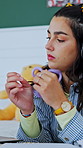 Student, laptop and girl with fidget toy for adhd, thinking and reading notes for lesson in bedroom. Music, headphones and woman in home for learning, education and study for exam with sensory tangle