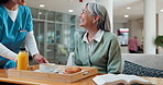 Caregiver, serving and old woman at house with food, support and breakfast for nutrition diet. Smile, nurse and senior person in lounge with bible, healthy meal and assisted living for morning brunch