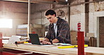 Man, carpenter and reading in factory with laptop, research and review design for production. Person, typing or pc in workshop for carpentry, online blueprint and schedule for manufacturing furniture