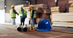 Helmet, carpentry and blueprint for safety in warehouse with engineer group in meeting for planning deal. People, carpenter and ppe with team for manufacturing, production or collaboration in factory