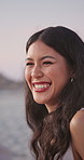 Woman, laughing and talking at beach, travel and listening to joke on holiday and getaway in nature. Outdoor, traveler and people on weekend break, happiness or funny conversation on coastal vacation