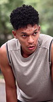 Tired, man and sweating at park for fitness, exercise and exhausted from intense training. Thinking, athlete and male person in nature with fatigue, sports challenge and runner breathing for recovery