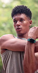 Man, park and stretching for fitness, serious with workout and warm up for athlete training outdoor. Person, arm muscle resistance and start of exercise for health, sports and breathing in nature