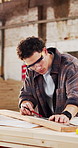 Man, carpenter and ruler in warehouse with timber, measurement and design process for accuracy. Woodworker, goggles and material in workshop for furniture manufacturing, plank and quality assurance
