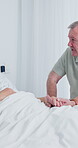 Couple, holding hands and old man in hospital room, talking and compassion for partner with illness. Healthcare, recovery and elderly person with spouse, discussion and support with gesture in clinic