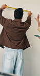 Man, renovation and wall measurement with couple in home, help or upgrade accuracy with tablet. People, tape and tool for length in house improvement, precision or tech for interior design from back