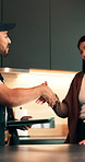 Woman, tablet and handshake in house with plumber for repairs, discussion and online quote for job. Home owner, client or shaking hands with tech for deal, agreement or renovation service in kitchen