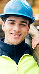Construction site, engineer and man with beam for building development or renovation with helmet. Confidence, portrait and happy architect with Infrastructure, about us or safety inspector with pride