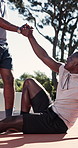 Support, aid or people on basketball court with lift, fitness hobby or practice for weekend match. Teamwork, smile or black men with helping hand, hoop sport or training together in outdoor activity.