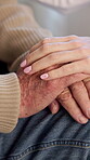 Nurse, help and holding hands with old person in nursing home, healthcare or compassion with gesture. Caregiver, sympathy and empathy for senior patient, retirement and comfort for rehabilitation