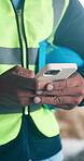 Phone, architect and hands of man on construction site for project, renovation or text message. Engineer, building inspection and property developer with person for communication and contractor