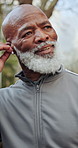 Smile, black man and earbuds in park for fitness, exercise and streaming podcast on retirement. Happy, senior person and runner in nature with playlist audio, listen to music and physical activity