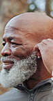 Happy, black man and earbuds in park for fitness, exercise and streaming podcast on retirement. Smile, senior person and runner in nature with playlist audio, listen to music and physical activity