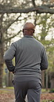 Back, fitness and running with black man outdoor on street for cardio training or workout. Commitment, exercise and wellness with runner in neighborhood for morning activity or physical health