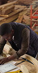 Carpentry, blueprint and engineer with tablet, sketching document and draft of woodworking plan. Timber, tech or black man with drawing, structure design or manufacturing report in furniture building