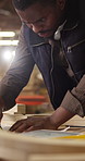 Carpentry, blueprint and black man with tablet, sketching document and draft of woodworking plan. Drawing, flare or engineer with tech, structure design or manufacturing report in furniture building.