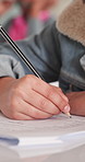 Writing, education and hands of teenager in classroom at high school for exam, test or quiz. Notes, learning and student studying with academic assessment, knowledge or essay summary on campus.