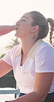 Athlete, drinking water and woman on break, outdoor and hydration with mineral liquid and nutrition. Sport, fitness and person with bottle after exercise, thirsty and cool down with beverage or detox