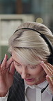 Call center, headache and woman in office with headset, frustration or stress in crm service. Telecom, mic or mature helpdesk advisor with migraine, burnout or communication issue in customer support