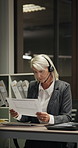 Night, woman and telemarketing in office with document, computer or check report for insurance claim. Late, mature person and consultant typing in business with desktop, paperwork or risk assessment.