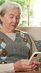 Phone, relax and senior woman on sofa in home living room for social media or text message. App, retirement and typing with old person in apartment for break, browsing or mobile communication